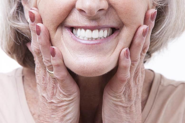 Closeup of woman smiling with dentures in Blairmore, Alberta at Crowsnest Dental